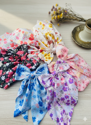 Colorful floral headbands on a light surface with a blurred background