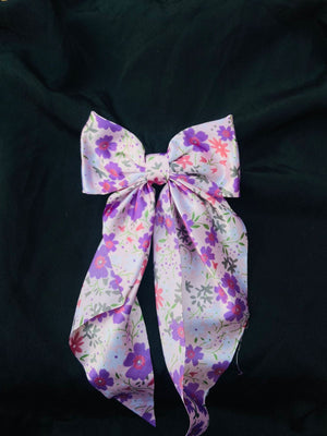 Lavender floral satin hair bow for women, featuring a lilac purple wildflower print on soft, high-quality silky fabric."