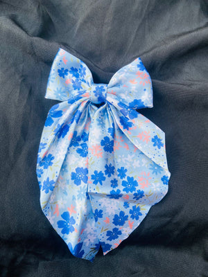Ocean Bloom aesthetic blue hair bow featuring delicate floral patterns on silky satin, ideal for summer outfits and beach-themed hairstyles."