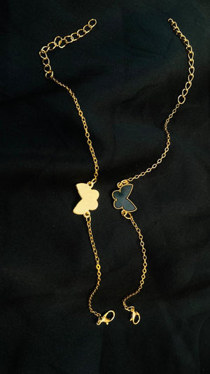 Gold butterfly-shaped necklaces on a black background