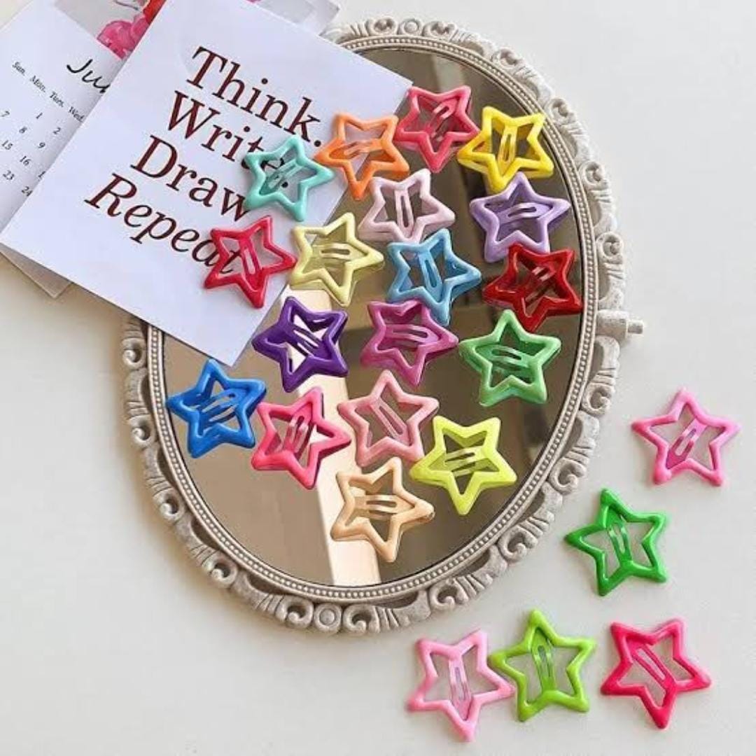 Colorful star-shaped paper clips on a decorative mirror with a motivational quote.