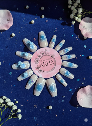 Nail art with floral designs on a blue background, featuring the brand 'ARHA'.