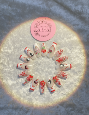 Decorative nail art designs arranged in a circular pattern on a textured surface with 'ARHA' branding.